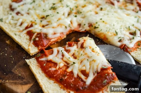A partially assembled pizza with sauce and cheese on Green Giant Cauliflower Pizza Crust