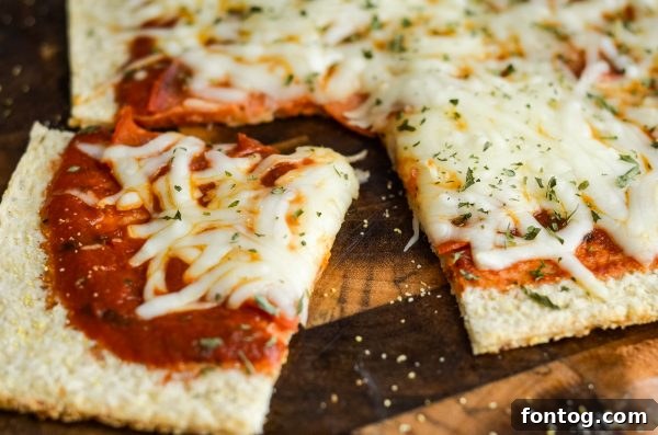 A freshly baked pepperoni pizza on a cauliflower crust, sliced and ready to serve
