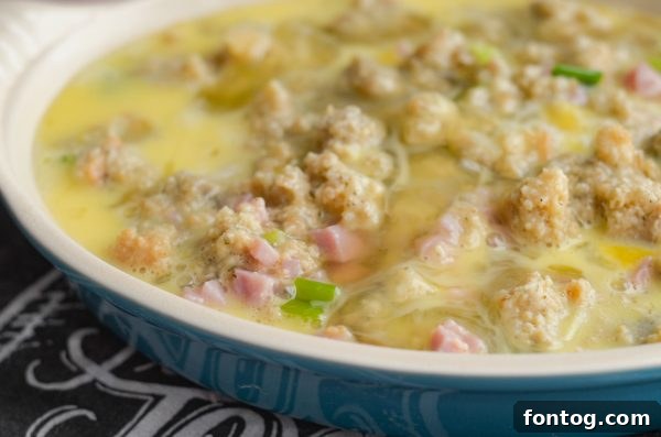 Preparing the Ham & Stuffing Frittata with fresh eggs
