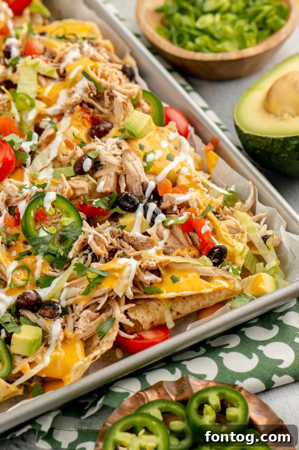 Crockpot chicken nachos, a gooey and savory party dish.
