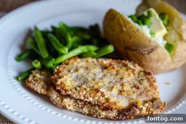 Air Fryer Ranch Breaded Pork Chops on a plate with a side of greens