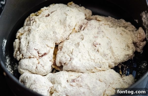Simple ingredients for gluten-free air fried chicken: chicken thighs and seasoned flour.