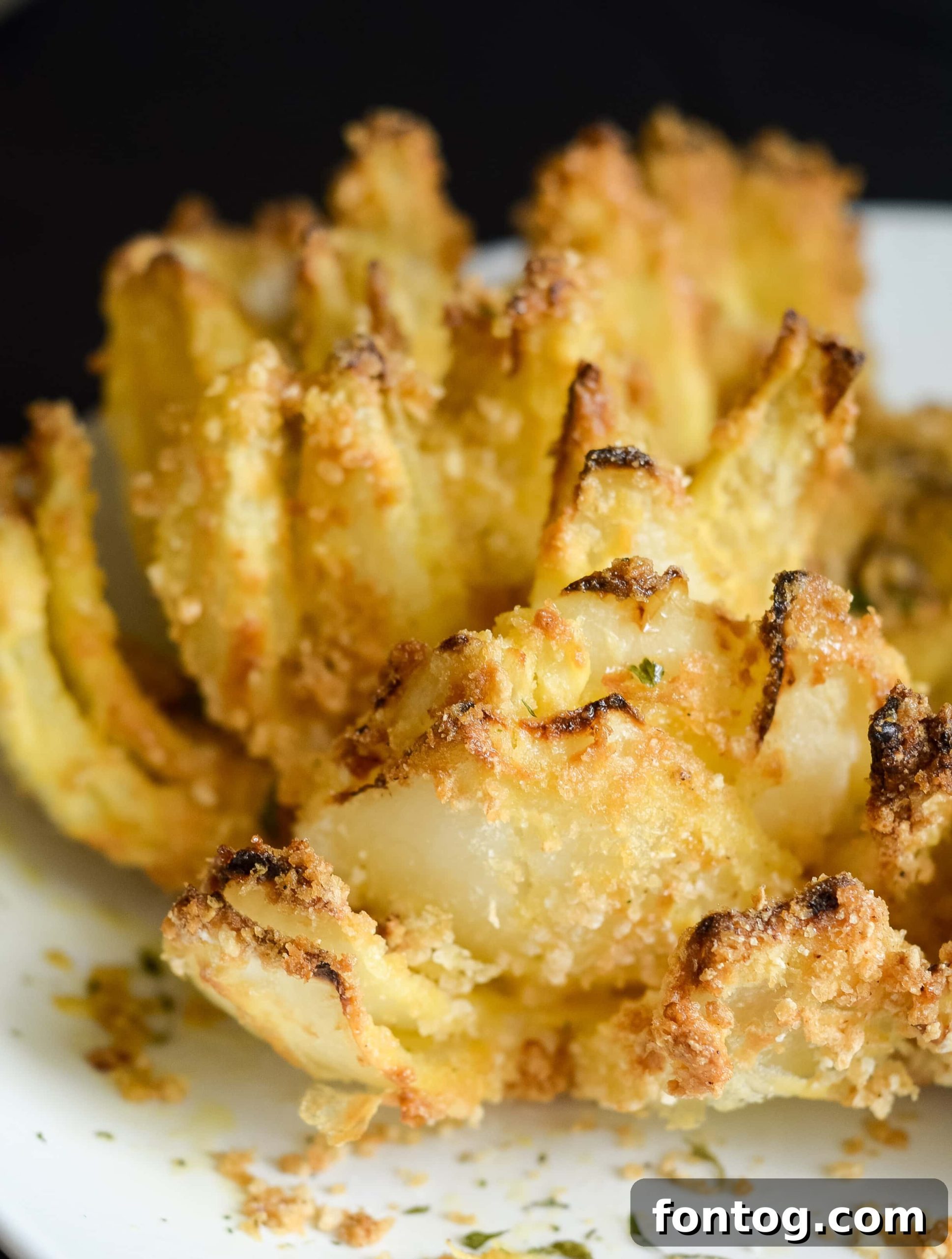 Easy Air Fryer Blooming Onion Recipe 3 Close-up of a gluten-free air fried blooming onion, crispy and golden brown.