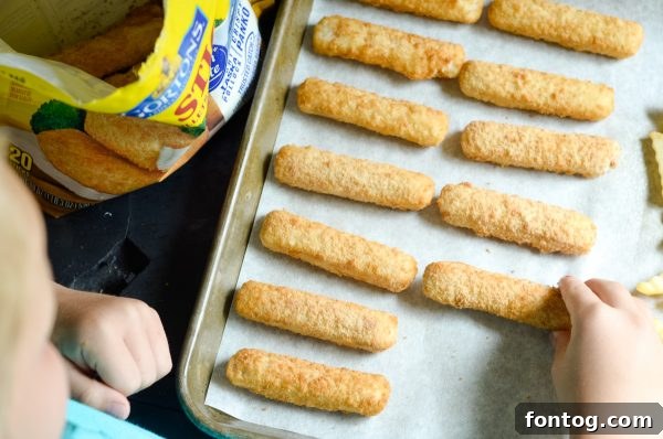 A child interacting with kitchen tools and Gorton's fish sticks, illustrating active participation in cooking.