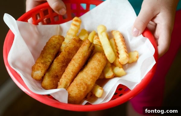 An adult supervising a child's hands in the kitchen, emphasizing safety during cooking activities.