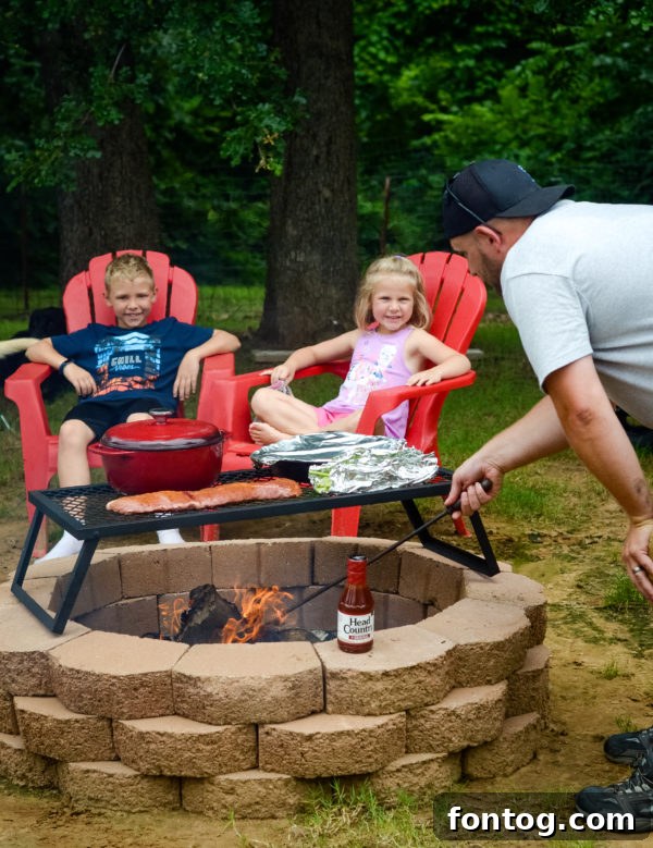 Family enjoying backyard camping with a tent and fire pit