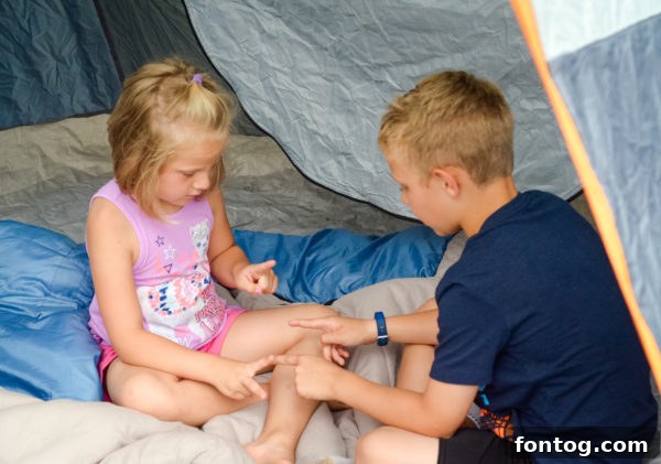 Family playing board games while backyard camping