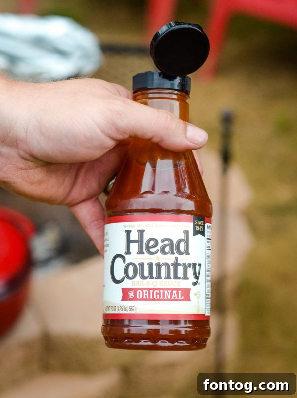 Bottles of Head Country BBQ sauce and seasoning on a picnic table