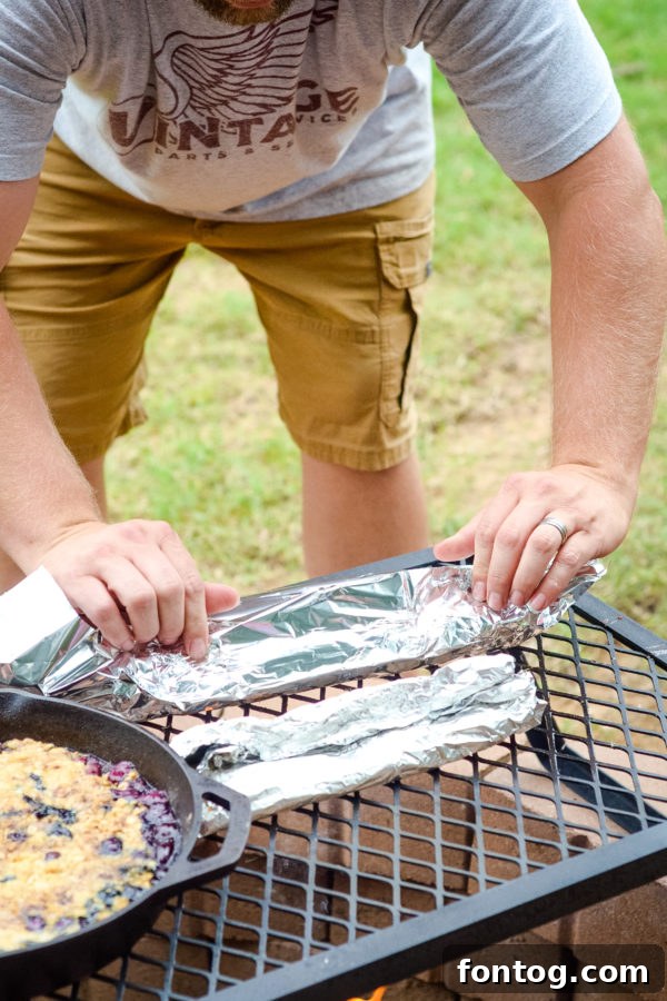 Variety of delicious food cooked over a backyard campfire