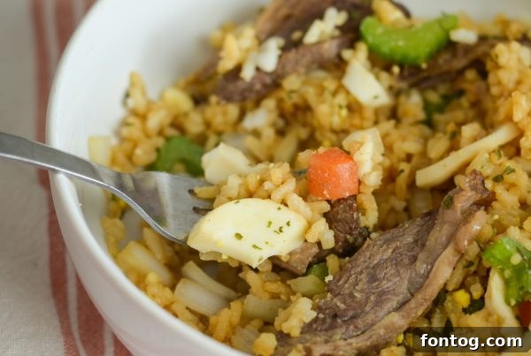 A serving of Air Fryer Beef Fried Rice in a bowl, ready to be enjoyed