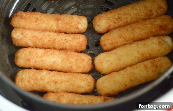 Gorton's Fish Sticks cooking in an air fryer basket, achieving a perfect crispy texture