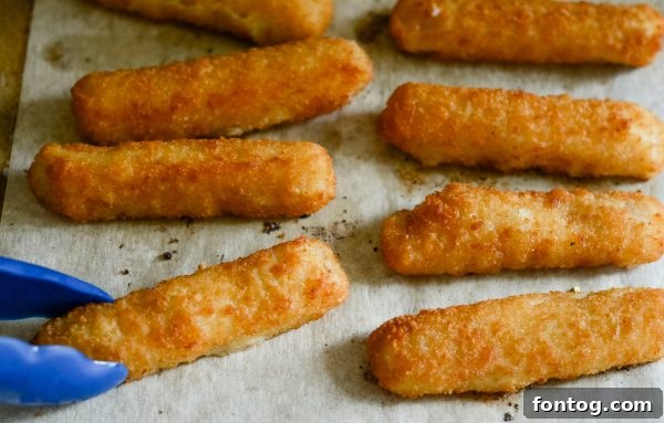 A comforting bowl of macaroni and cheese topped with golden Gorton's fish sticks