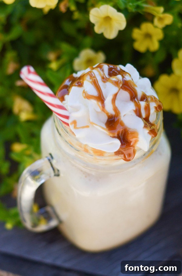 Delicious Frozen Caramel Coffee topped with whipped cream and caramel drizzle, perfect for a sweet treat.