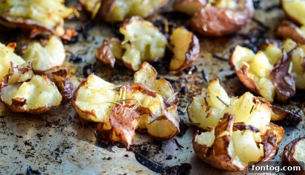Ingredients laid out for Crash Hot Potatoes: small red potatoes, olive oil, salt, pepper, and fresh rosemary.