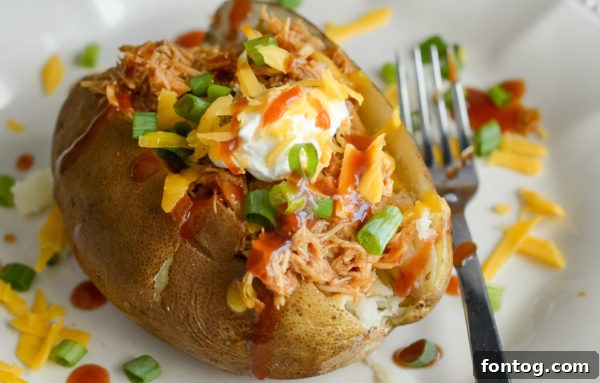 Easy Ninja Foodi Slow Cooker Pulled BBQ Chicken 4 Ninja Foodi Slow Cooker BBQ Chicken served on a plate.