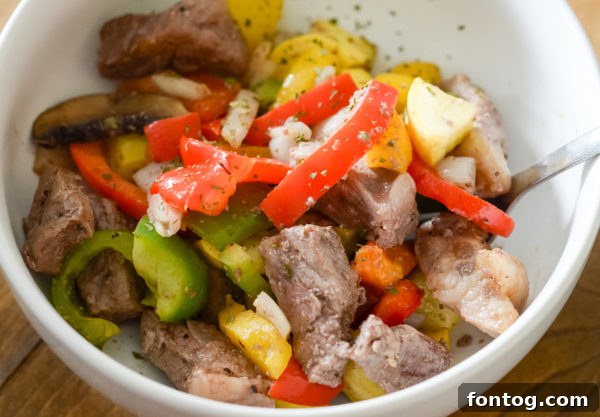 Sliced raw mushrooms and diced onions ready for cooking.