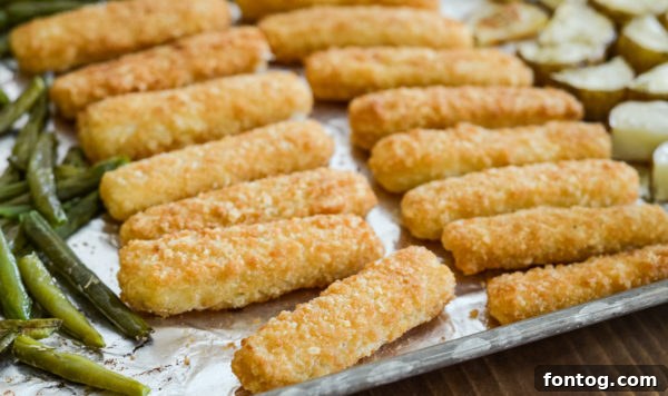 Sheet pan with fish and vegetables ready for oven