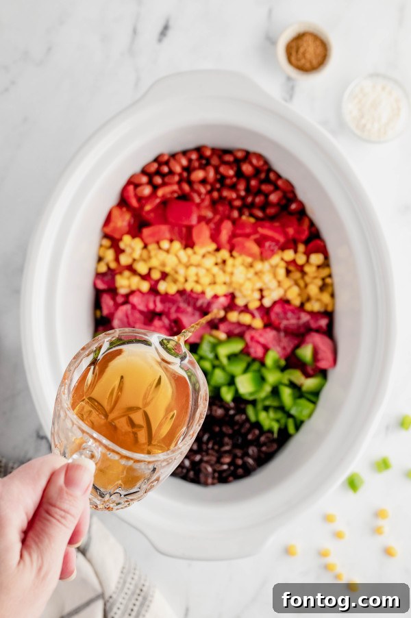 slow cooker taco stew in a bowl with a spoon