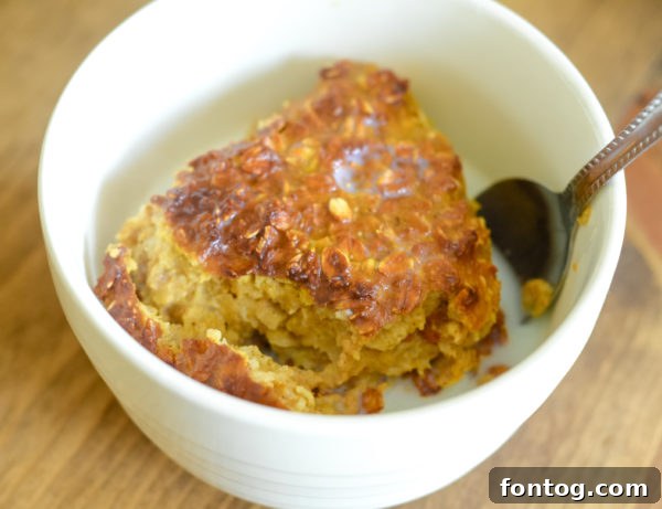 Ninja Foodi Baked Pumpkin Oatmeal in a bowl with spoon
