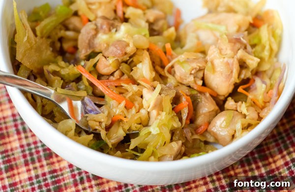 Close-up of chicken chunks cooking in a Ninja Foodi pot, forming the protein base for the Egg Roll in a Bowl.