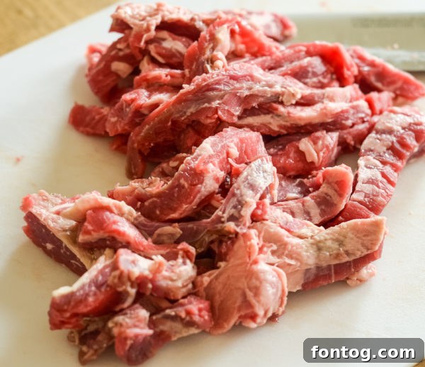 Uncooked skirt steak on a cutting board, ready to be sliced for fajitas.