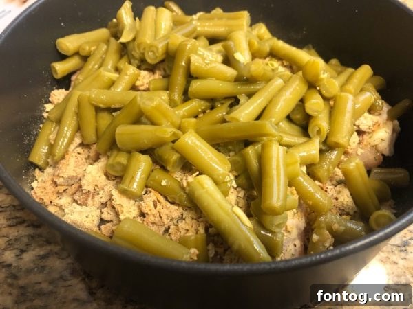 Ninja Foodi Express Chicken and Stuffing 5 Raw chicken thighs in a casserole dish, ready for Ninja Foodi cooking