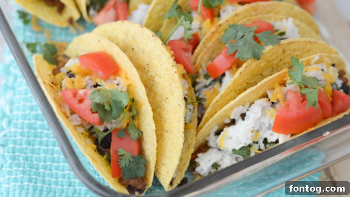 Hearty Baked Black Beans & Rice Tacos with fresh toppings.