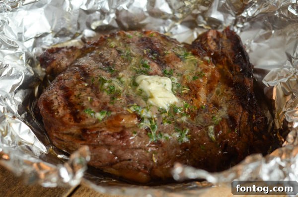 Melted garlic butter coating a ribeye steak