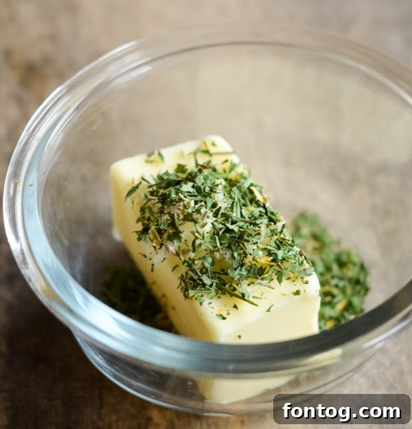 Bowl of freshly prepared garlic butter with herbs