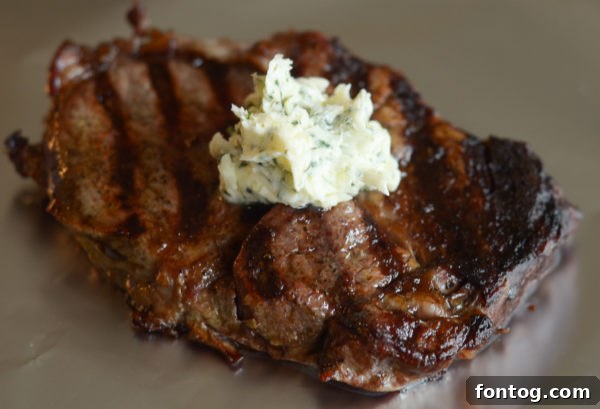 Grilled ribeye on foil with garlic butter on top