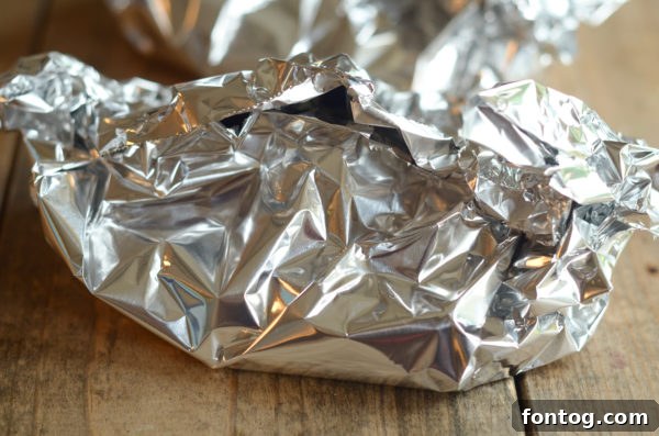 Ribeye steak wrapped in foil with garlic butter