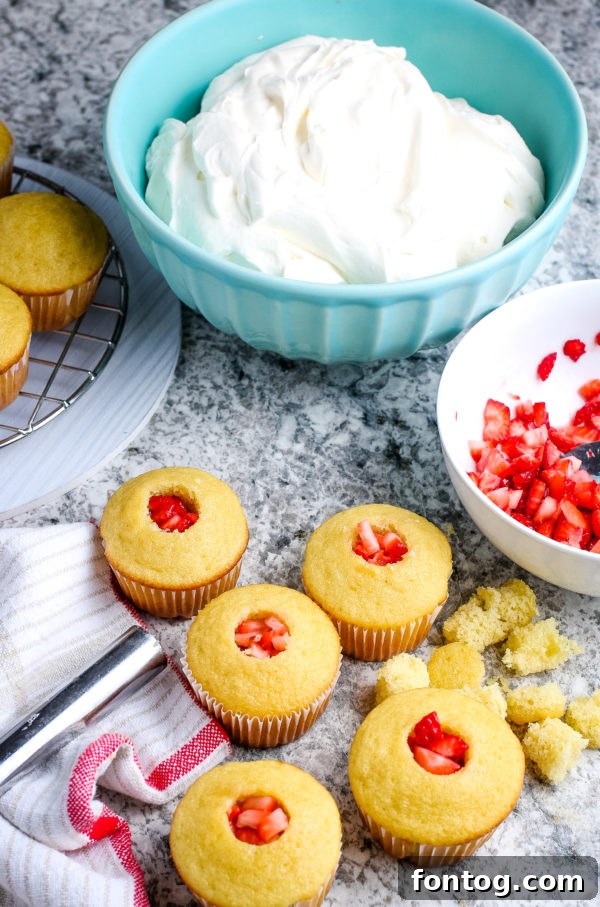 Coring a Gluten-Free Strawberry Shortcake Cupcake with a frosting tip