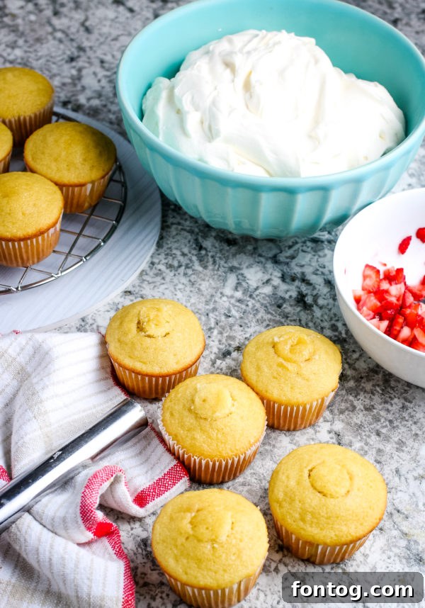 Filling a cored Gluten-Free Strawberry Shortcake Cupcake with chopped strawberries