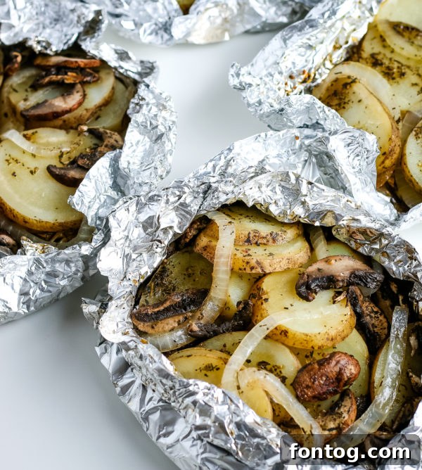 Close-up of grilled potatoes in foil, showing tender slices