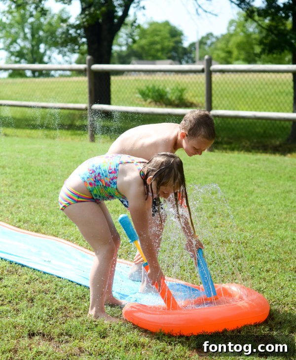 Backyard Bash: Your Family's Ultimate Game Night 5 Kids playing with water guns in the garden during summer