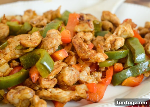 Air fryer chicken fajitas with colorful bell peppers and onions, a healthy and quick dinner.