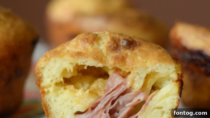 Golden brown Ham & Cheese Stuffed Popovers on a baking tray
