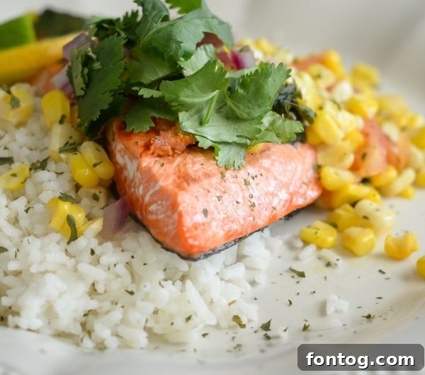 A vibrant grilled salmon fillet, beautifully cooked, ready to be topped with roasted corn salsa.