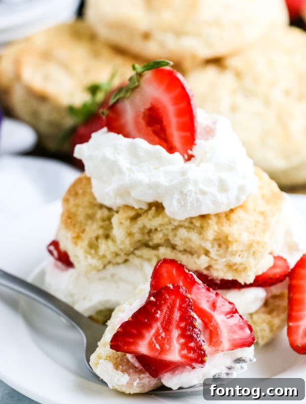 Plated gluten-free strawberry shortcake with a fork, ready to eat
