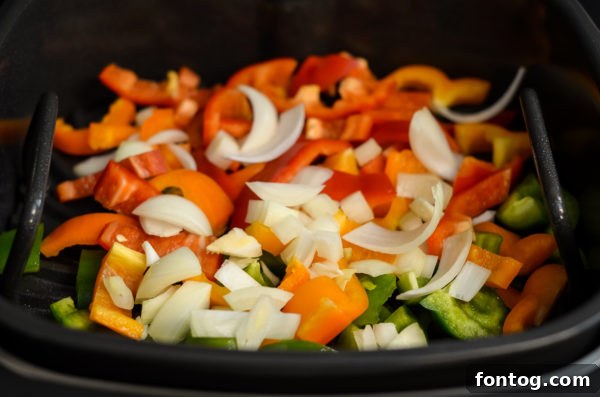 Close-up of bell peppers and onions cooking on the Ninja Foodi Grill grate