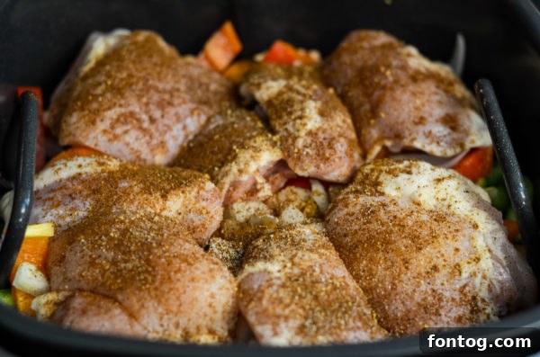Uncooked chicken thighs seasoned and ready for the grill
