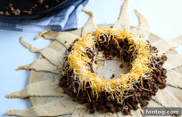 Simple Fiesta Crescent Ring 6 Filling crescent roll taco ring with seasoned ground beef and cheese