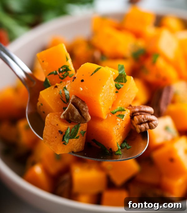 Close-up of roasted butternut squash cubes with visible caramelization.