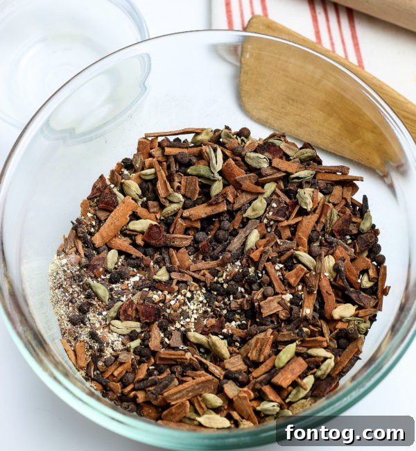 Cozy Mulling Spice Blend 3 Mulling Spices in a wooden bowl with a rustic background