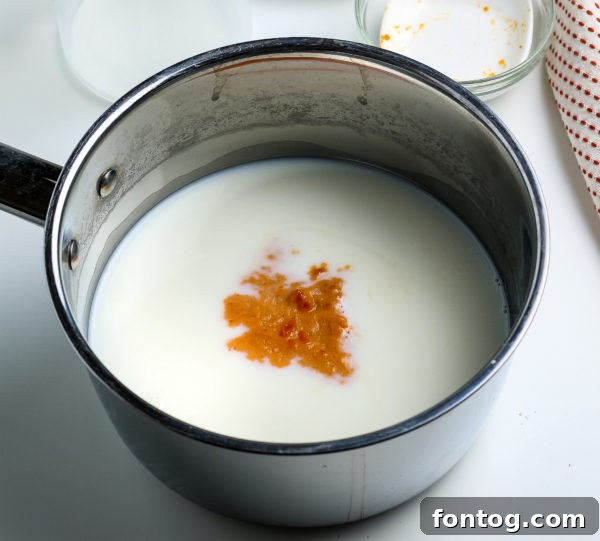 Crafting Your Perfect Pumpkin Spice Latte 4 Ingredients for pumpkin spice latte simmering on a stovetop