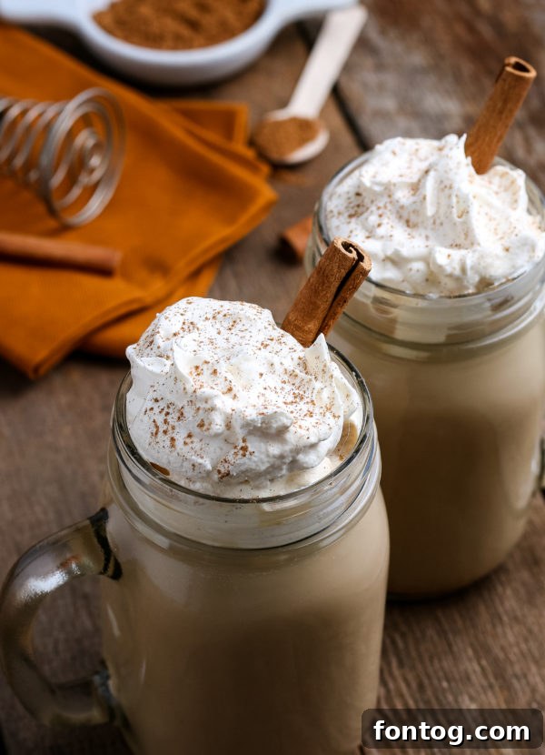 Crafting Your Perfect Pumpkin Spice Latte 8 A person holding a homemade pumpkin spice latte mug