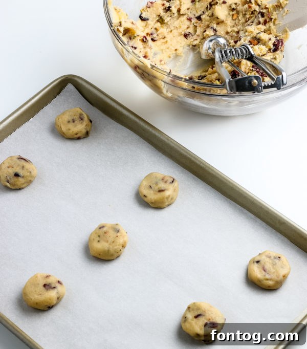 Finished Cranberry Pistachio Cookies with white chocolate drizzle and sprinkles