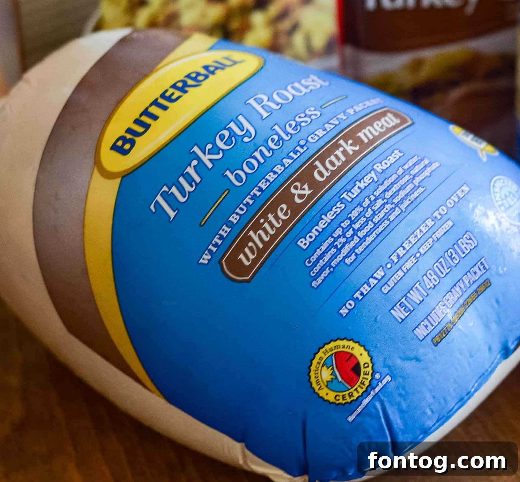 Raw boneless turkey roast coated in rosemary and garlic seasoning, ready for the air fryer.