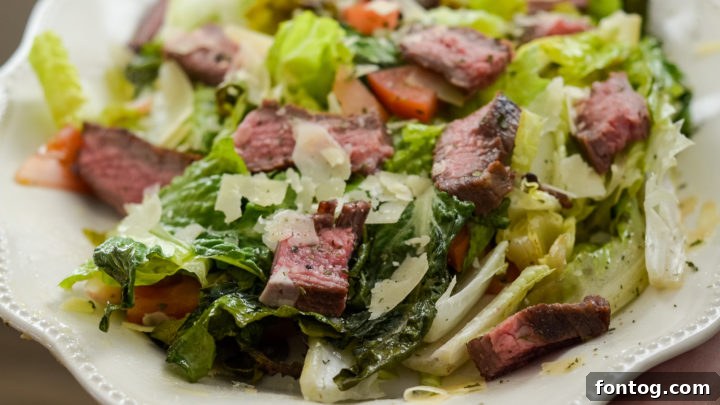 Fresh Grilled Romaine Salad topped with perfectly glazed flank steak