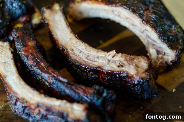 Grilled baby back ribs in the Ninja Foodi Grill, halfway through cooking.